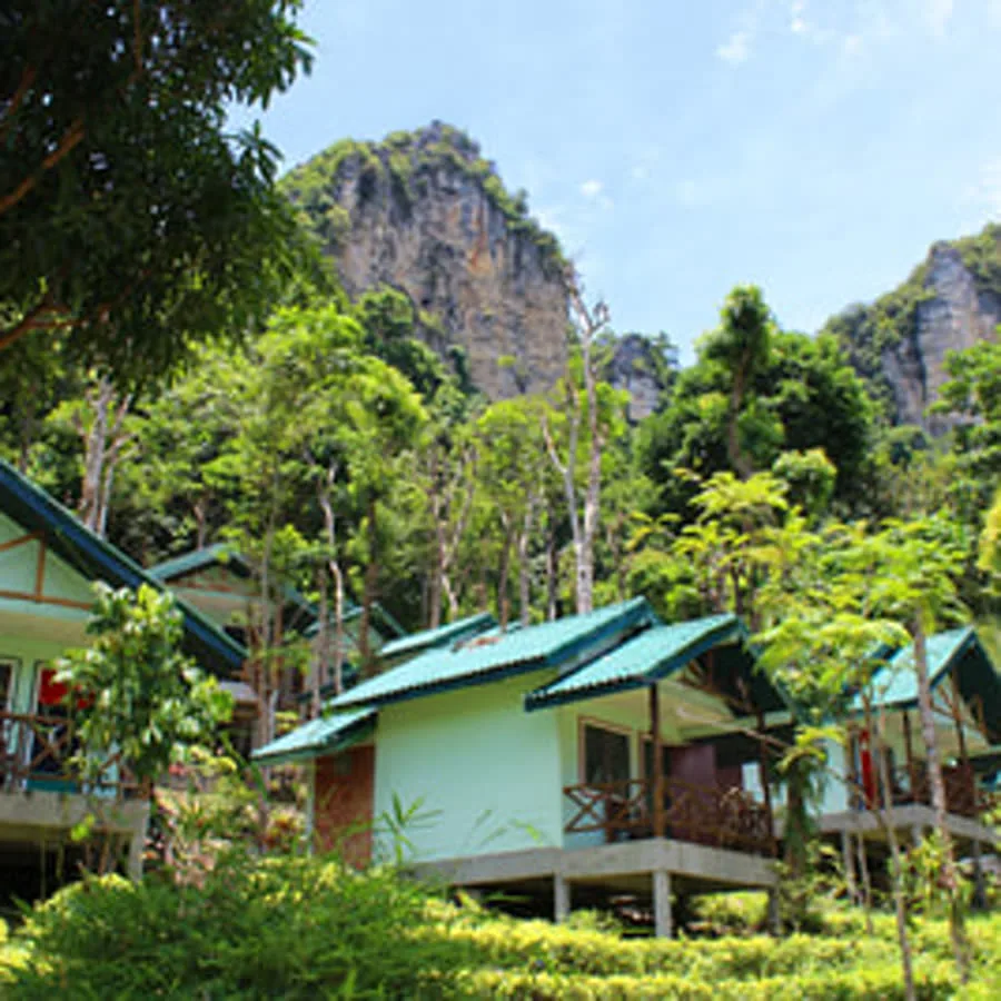 A close view of tropical bungalows and greenery in Tonsai.